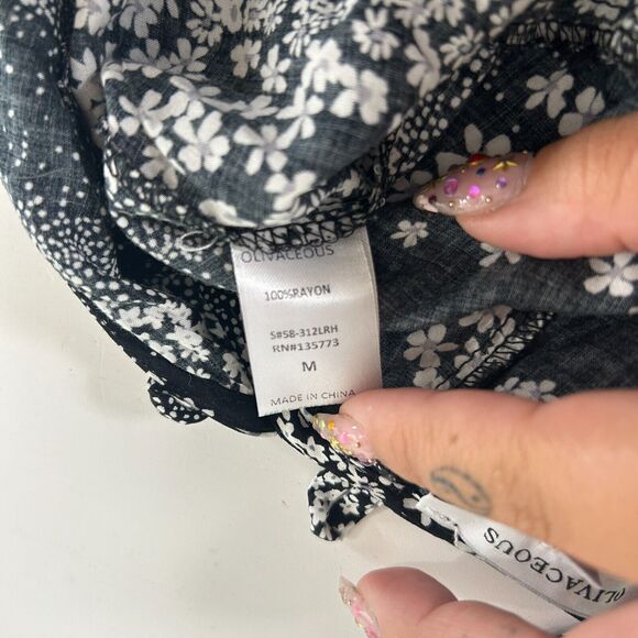 Olivaceous Black and White Floral Halter Tie Neck Open Back Flowy Romper Medium - Picture 6 of 11